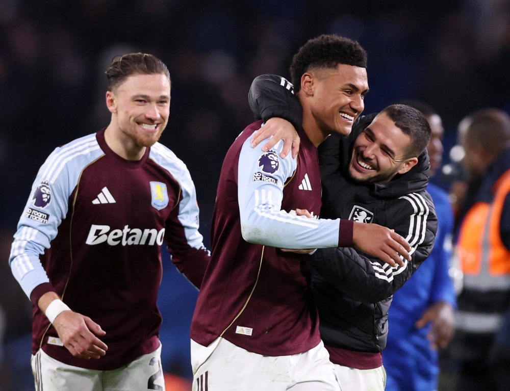Aston Villa's Ollie Watkins, Emiliano Buendia and Matty Cash celebrate after the match 