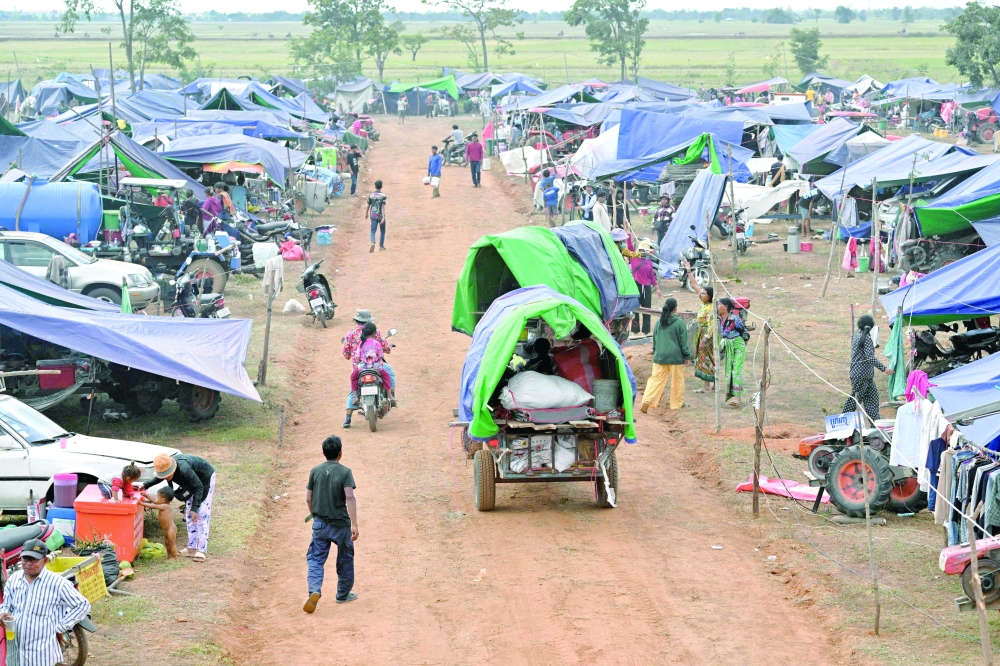 Displaced people arrive at a temporary camp in Cambodia's Oddar Meanchey province. — AFP