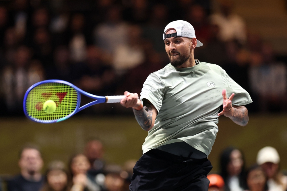 Australia's Nick Kyrgios hits a return against Belarus’ Aryna Sabalenka 