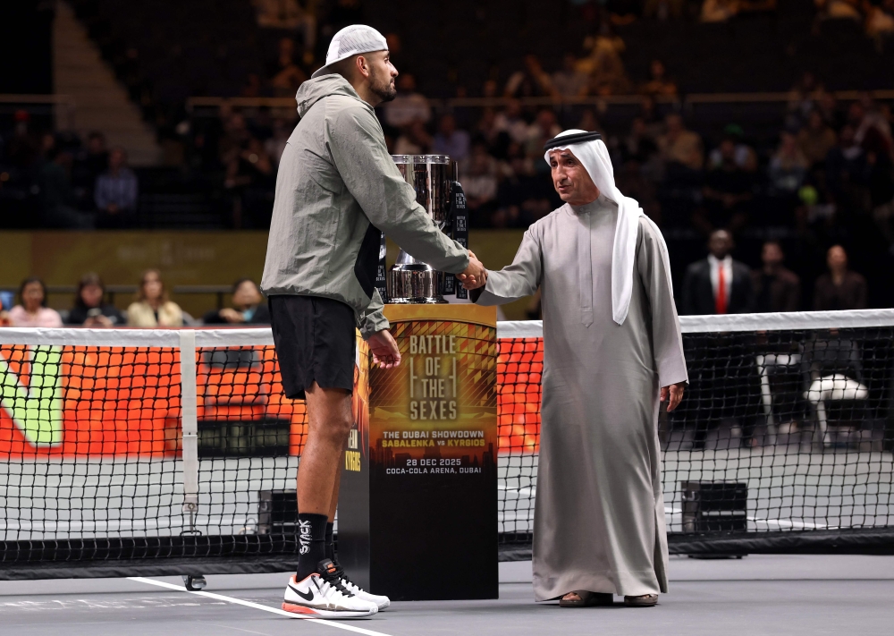 Kyrgios (L) shakes hands with former UAE national tennis player and President of the UAE Padel Association, Sheikh Saeed Bin Maktoum Bin Juma Al Maktoum, 
