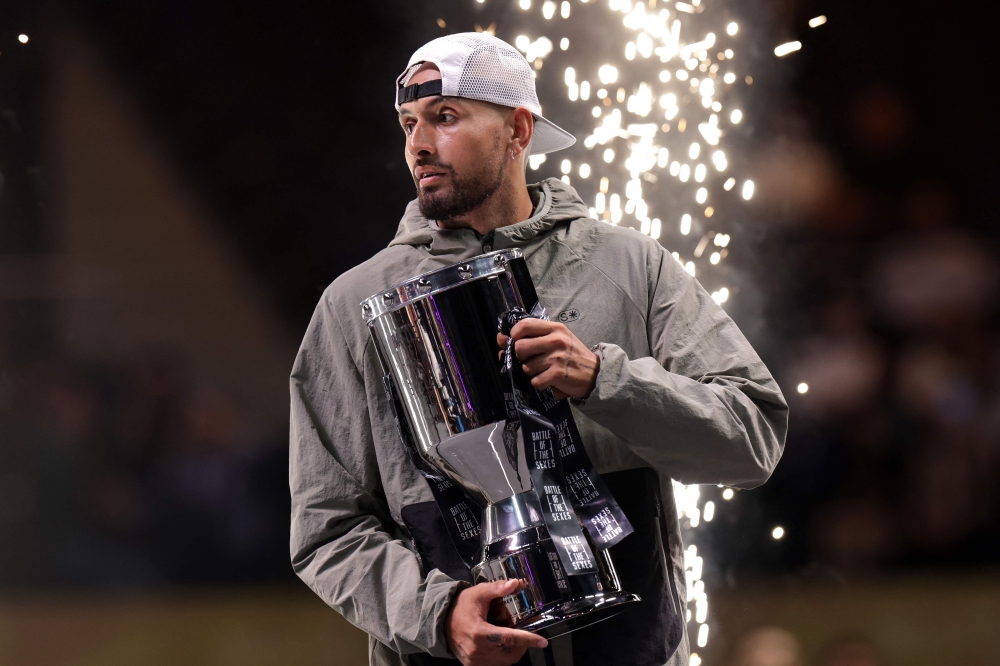 Australia's Nick Kyrgios holds his trophy after  the winning 