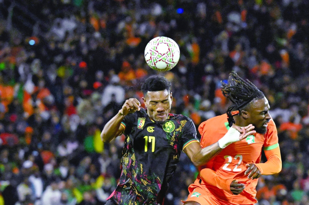 Cameroon's defender #17 Samuel Kotto (C) fights for the ball with Ivory Coast's forward #22 Sebastien Haller (R) during the Africa Cup of Nations (CAN) Group F football match between Ivory Coast and Cameroon at Marrakesh Stadium in Marrakesh on December 28, 2025.   (Photo by Khaled DESOUKI / AFP)