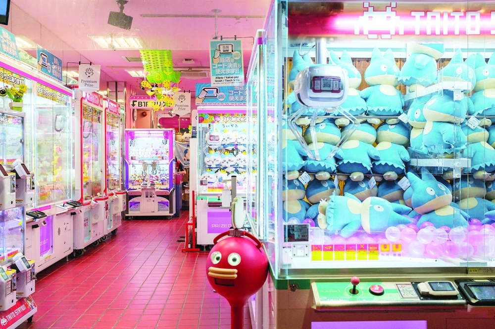 This picture taken on June 6, 2024 shows a claw crane game shop in Akihabara district of Tokyo. As school and work wraps up, crowds gradually fill Tokyo's many bustling arcade halls —- not to battle it out in fighting games, but to snag plush toys from claw machines. - To go with 'JAPAN-ANIMATION-GAME-ARCADE, FOCUS' by Mathias Cena

