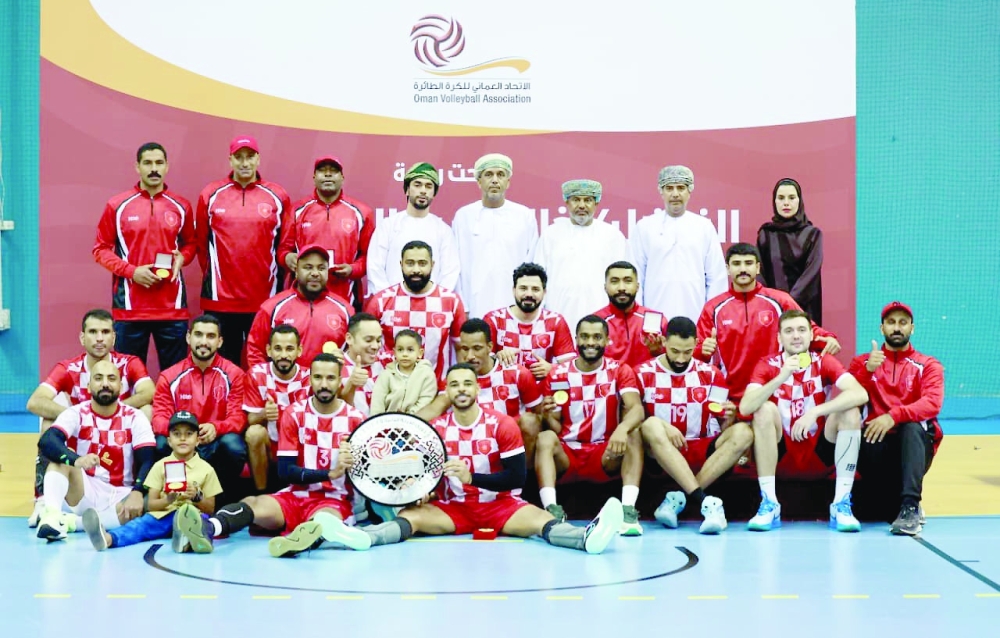 Al Hamra Club players pose with the Second Division Volleyball League shield along with officials. — Ahmed al Maamari