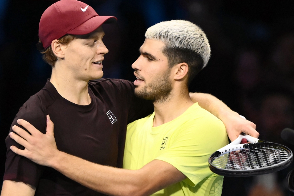 (FILES) Italy's Jannik Sinner (L) is congratulated by Spain's Carlos Alcaraz at the ATP Finals tennis tournament, in Turin.