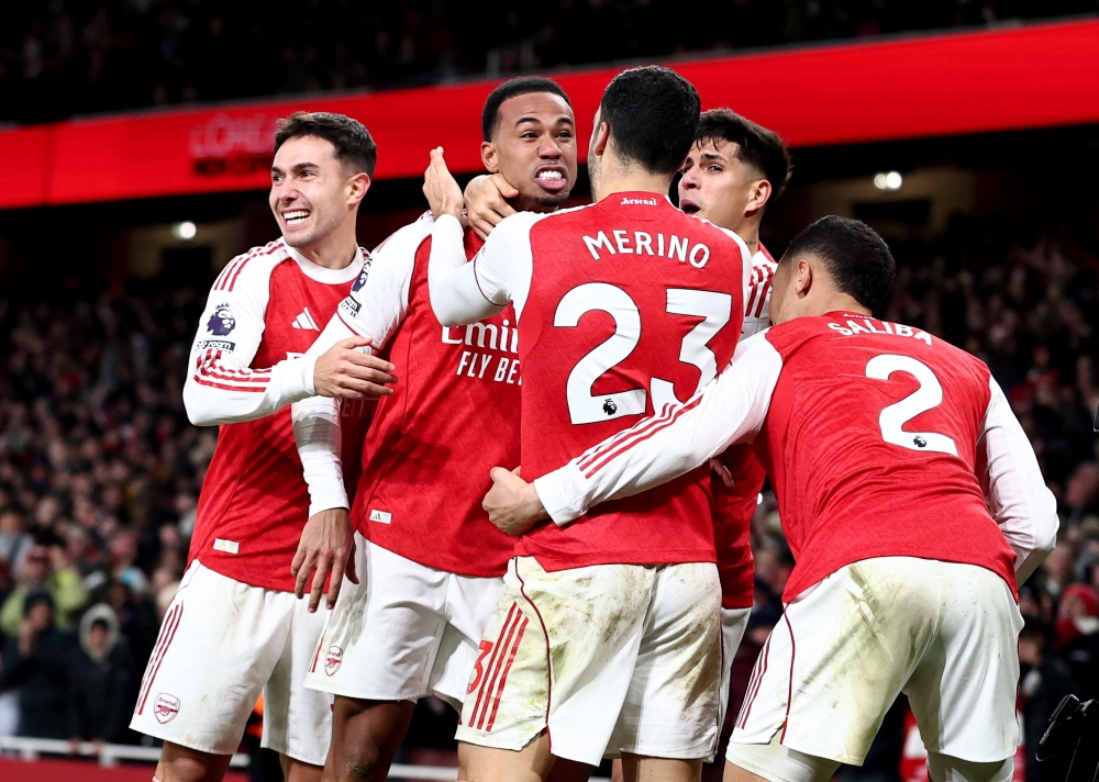 Arsenal's Gabriel celebrates scoring their first goal with Martin, Mikel, Hincapie and William