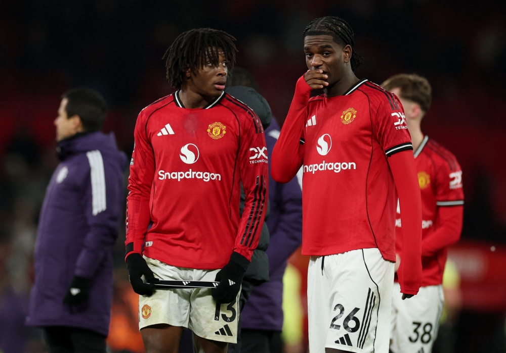 Manchester United's Patrick Dorgu reacts with Ayden Heaven after the match