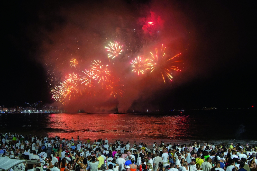 People watch the traditional New Year's fireworks at Copacabana Beach in Rio de Janeiro, Brazil. — AFP