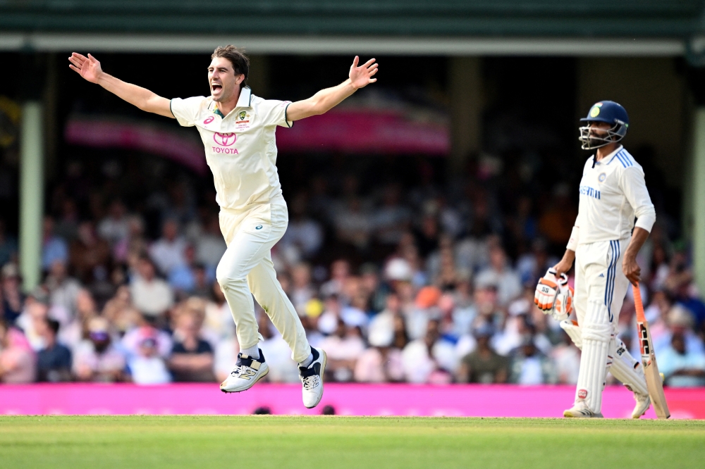 Pat Cummins celebrates after taking the wicket of India's Rishabh Pant
