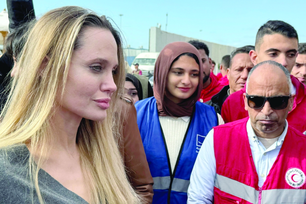 US actress Angelina Jolie meets with Red Crescent employees at the Egyptian Rafah border crossing to inspect aid entering the Palestinian Gaza Strip. — AFP