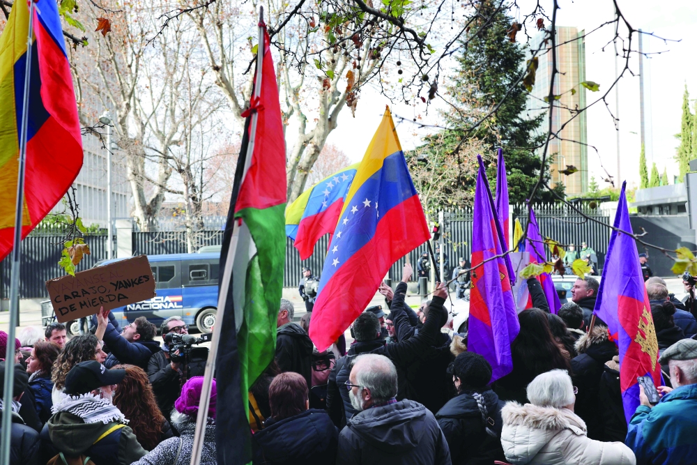 Protestors take part in a demonstration against the US operation, in front of the US Embassy in Madrid. — AFP