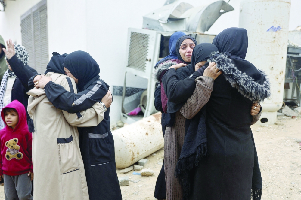 Relatives react during the funeral of a victim from a fire that started after the inhabitants ignited candles to light up inside their tents at a camp for displaced Palestinians in Gaza City on January 2, 2026. Beginning in October 2025, a fragile ceasefire has so far halted two years of war between Israel and Hamas in the Gaza Strip despite both sides trading accusations of truce violations. (Photo by Omar AL-QATTAA / AFP)