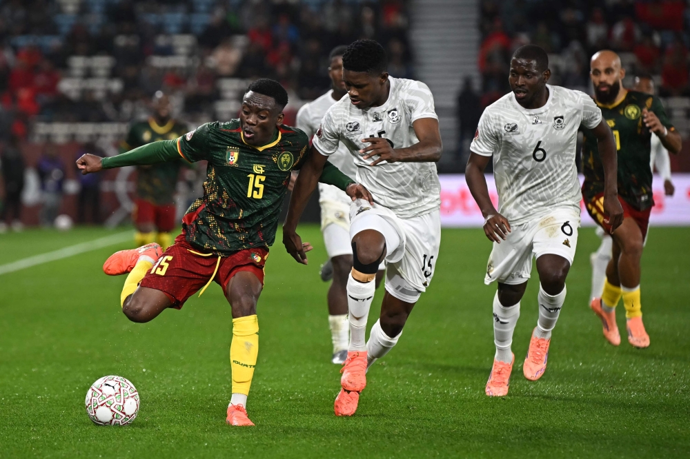 Cameroon's midfielder #15 Arthur Avom controls the ball next to South Africa's midfielder #15 Bathusi Aubaas 