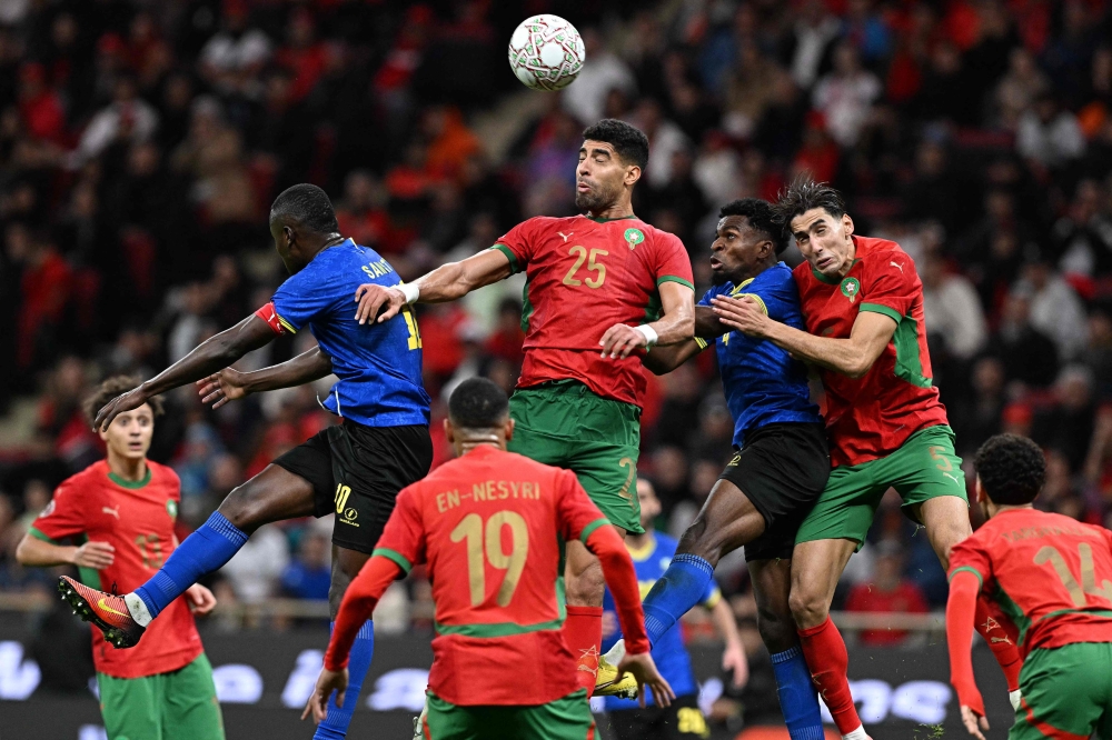Morocco's defender #25 Adam Masina jumps for a header