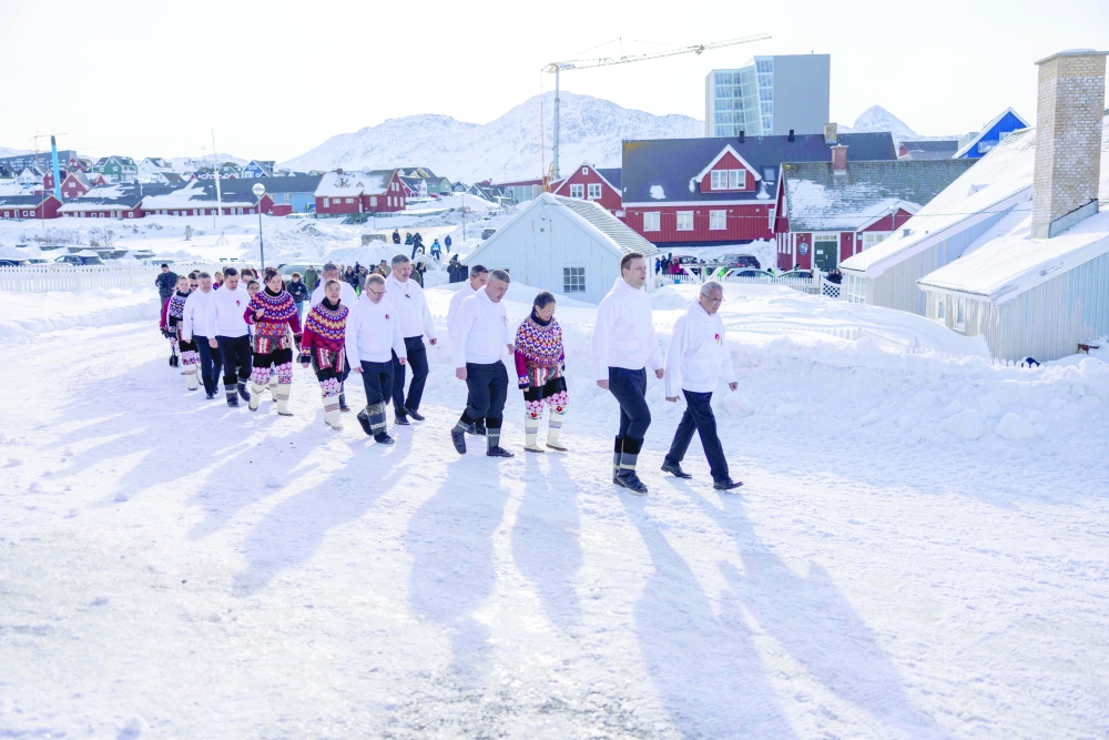 Jens-Frederik Nielsen (2nd R), Prime Minister of Greenland, and MPs take part in a procession in Nuuk.— AFP