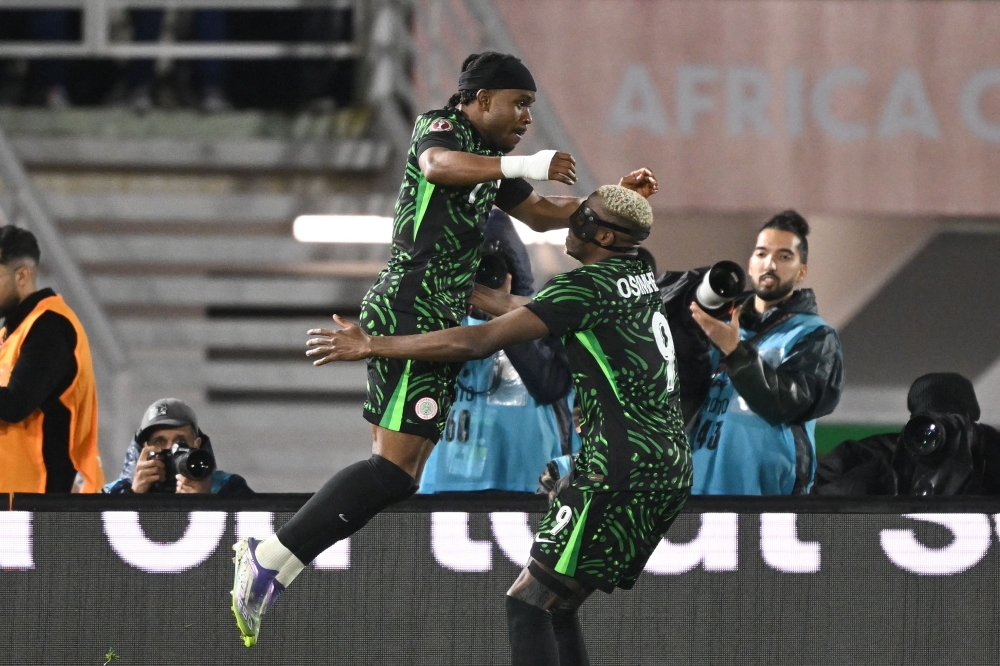 Nigeria's Osimhen (R) celebrates scoring the team's third goal with Lookman 