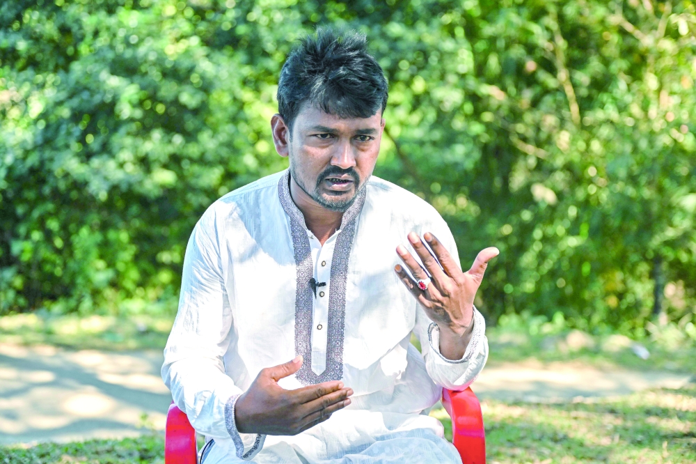 This photograph taken on December 19, 2025 shows farmer Dudu Mia speaking during an interview with AFP at the Bangladesh-Myanmar frontier village of Naikhongchhari in Bandarban district. In the dense hill forests along Bangladesh's border with war-torn Myanmar, villagers are losing limbs to landmines, casualties of a conflict not of their making. - TO GO WITH 'Bangladesh-Myanmar-Conflict-Landmine' FOCUS
 (Photo by Munir UZ ZAMAN / AFP) / TO GO WITH 'Bangladesh-Myanmar-Conflict-Landmine' FOCUS