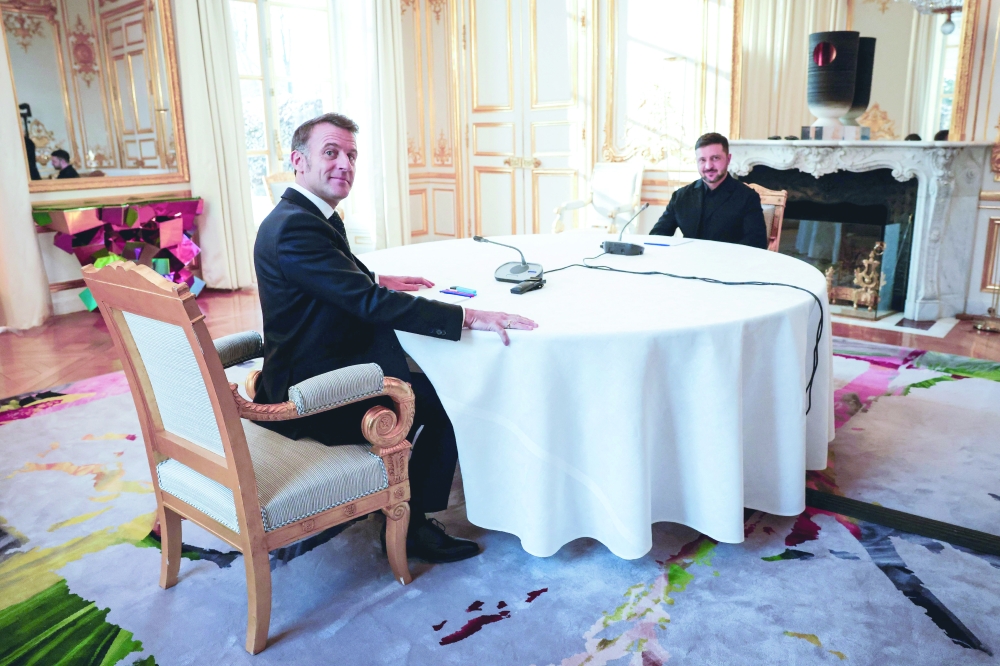 France's President Emmanuel Macron (L) meets with Ukraine's President Volodimir Zelenski (R) at the Elysee Palace. — AFP
