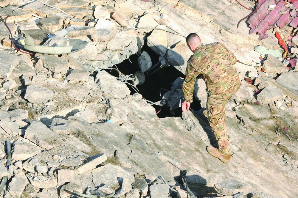 A security personnel inspects the site of a destroyed building, in southern Lebanon. — AFP