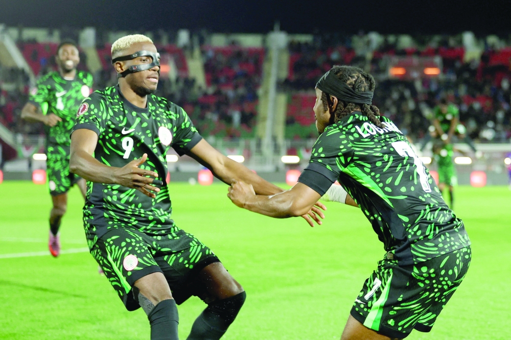 Soccer Football - CAF Africa Cup of Nations - Morocco 2025 - Round of 16 - Nigeria v Mozambique - Fez Stadium, Fes, Morocco - January 5, 2026 Nigeria's Victor Osimhen celebrates scoring their third goal with Ademola Lookman REUTERS/Amr Abdallah Dalsh