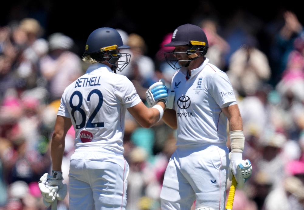 England's Jacob Bethell celebrates with Joe Root after reaching his half century 