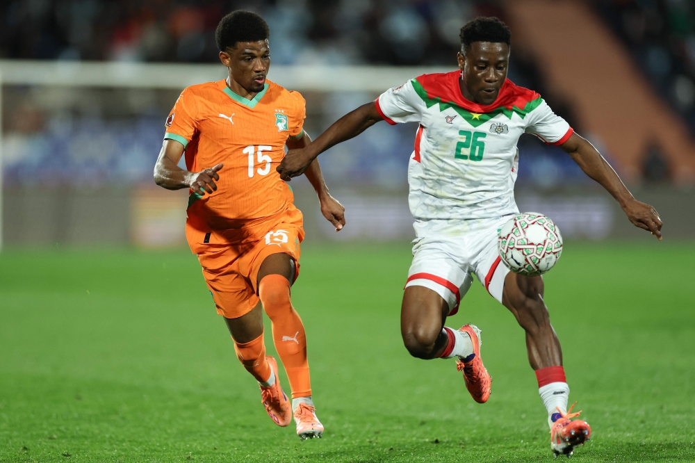 Ivory Coast's  Amad Diallo and Burkina Faso's Arsene Kouassi compete for the ball 