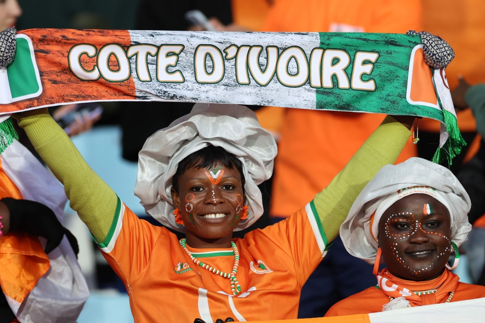 An Ivory Coast fan holds a scarf ahead of the Africa Cup of Nations (CAN) 