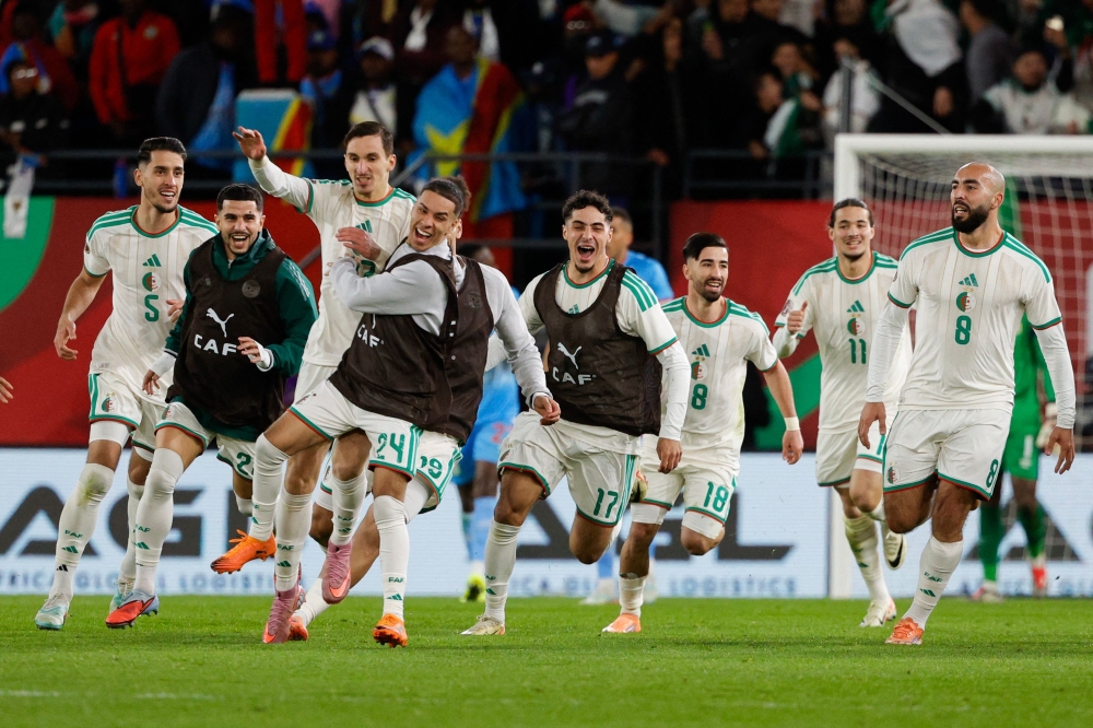 Algeria's forward #27 Adil Boulbina (3L) who scored his team's first goal celebrates with teammates