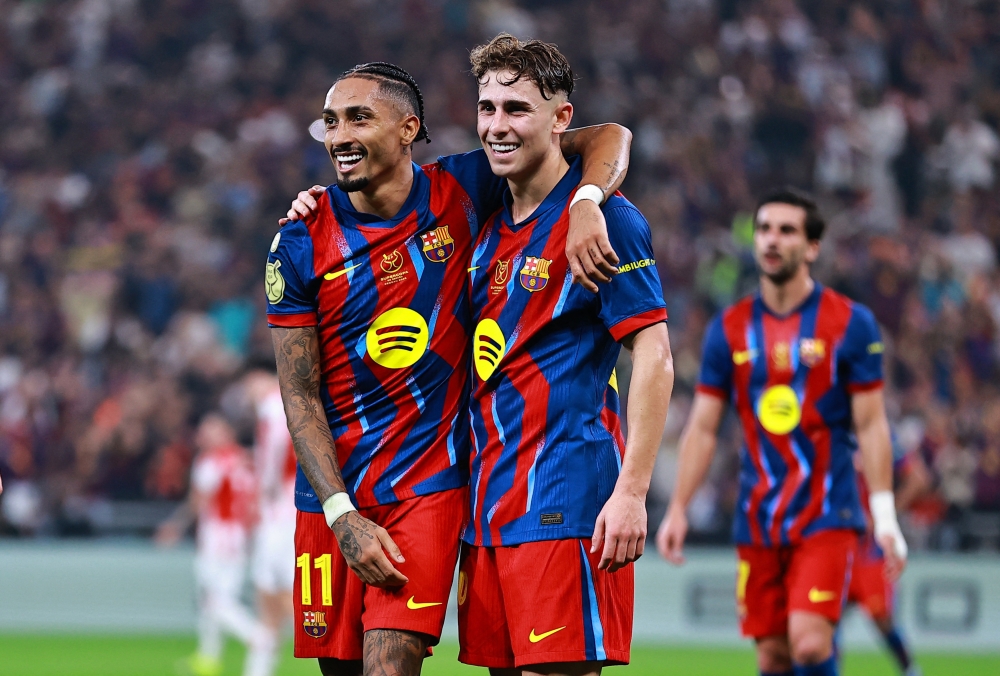 Barcelona's Raphinha celebrates scoring their fourth goal with Fermin Lopez