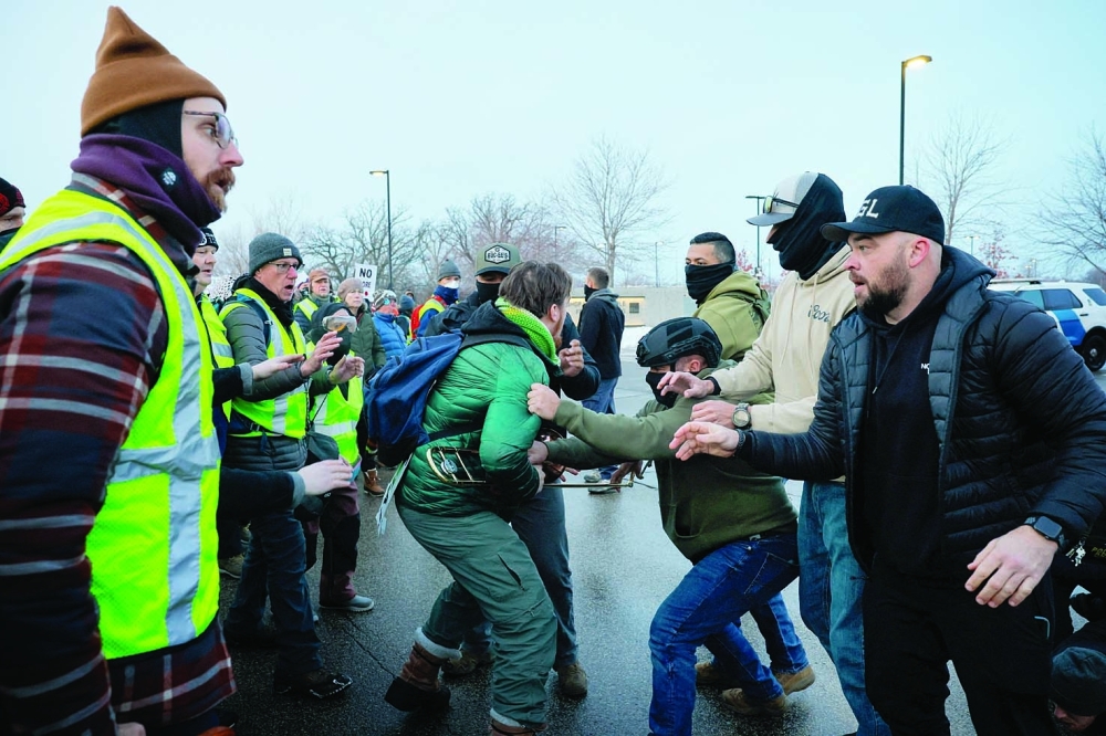 A federal agent detains a demonstrator during a rally against increased immigration enforcement across the city, outside the Whipple Building in Minneapolis, Minnesota. — Reuters