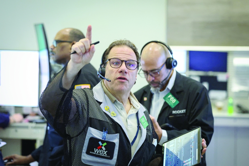Futures-options traders work on the floor at the New York Stock Exchange's NYSE American (AMEX) in New York City. — Reuters