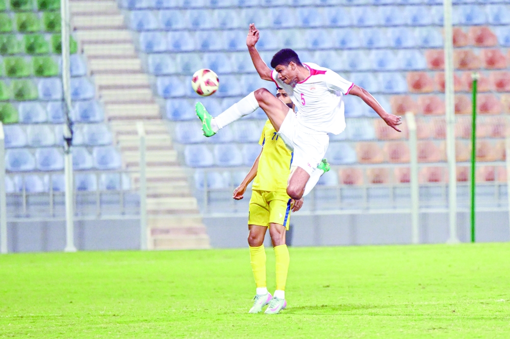 Oman Club player kicks the ball in front of Bahla player. — Abdulwahid al Hamadani