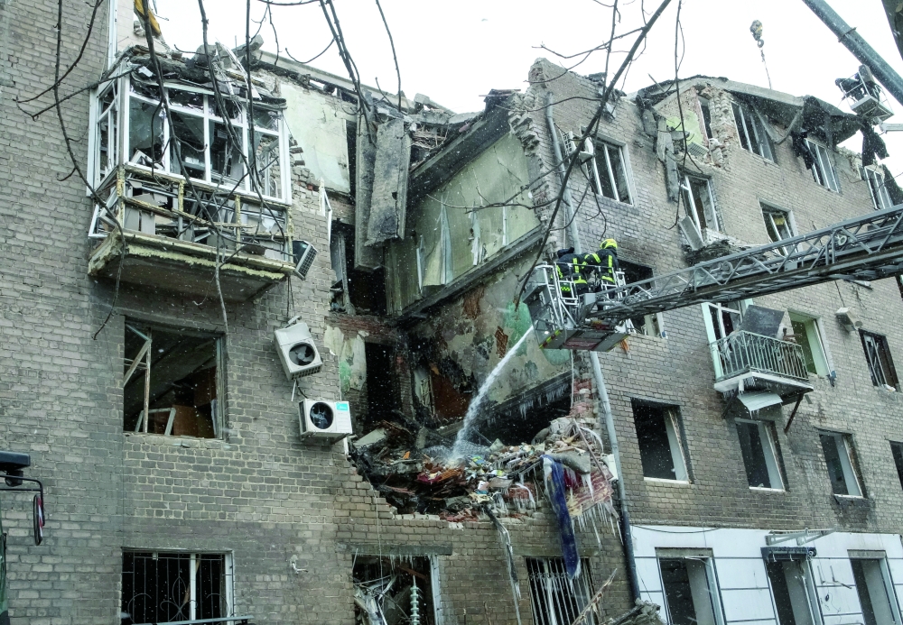 Firefighters work at the site of the apartment building hit by a Russian missile strike late yesterday, in the city of Kryvyi Rih, Dnipropetrovsk region. — Reuters