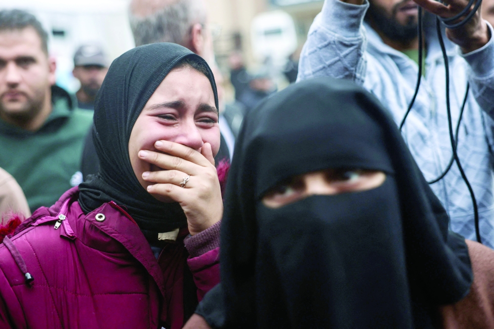 A Palestinian woman reacts as families arrive to collect the bodies of loved ones at the Nasser Hospital in Khan Yunis, in the southern Gaza Strip. — AFP