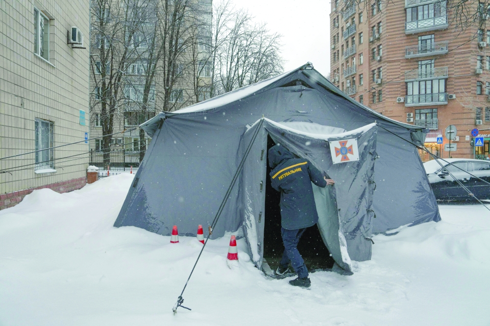 A Ukrainian rescue worker opens a tent of Point of Invincibility in Kyiv. — AFP