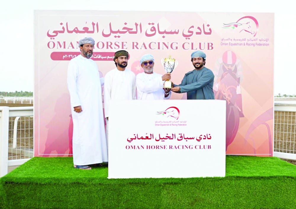 The owner of a winning horse receives the trophy. — Mohammed al Balushi