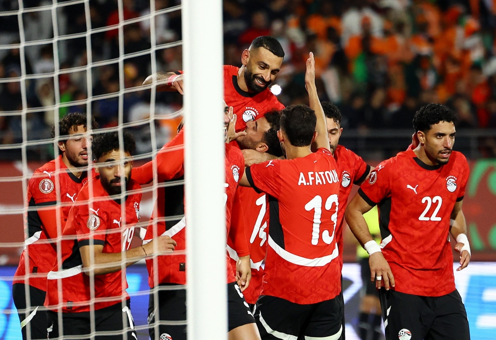 Egypt's Mohamed Salah celebrates scoring their third goal with teammates