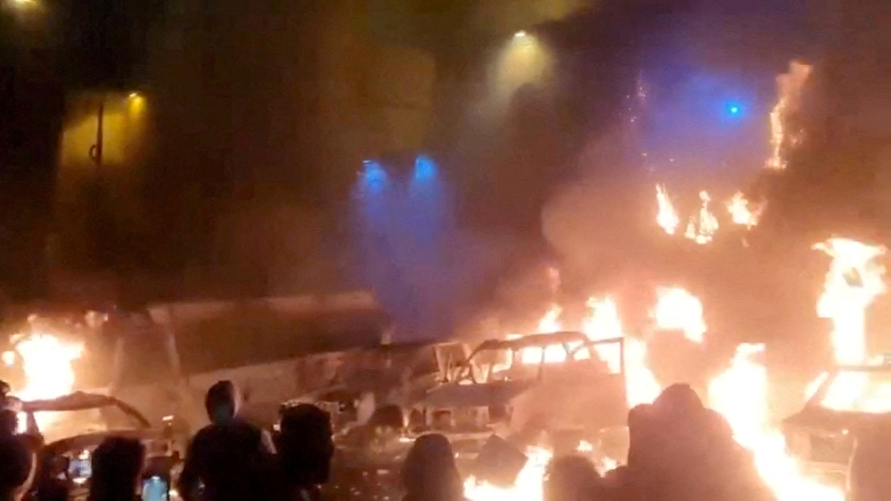 Protesters gather as vehicles burn, amid evolving anti-government unrest, in Tehran, Iran, in this screen grab obtained from a social media video released on January 9