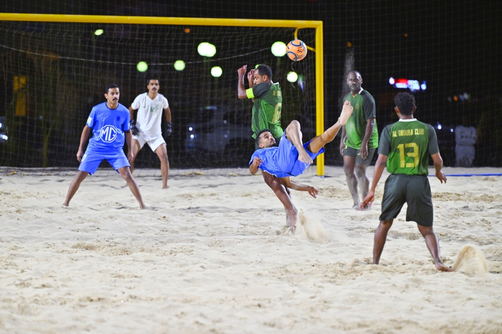 A spectacular bicycle kick lights up the night during a thrilling beach football showdown. —  Faisal al Balushi