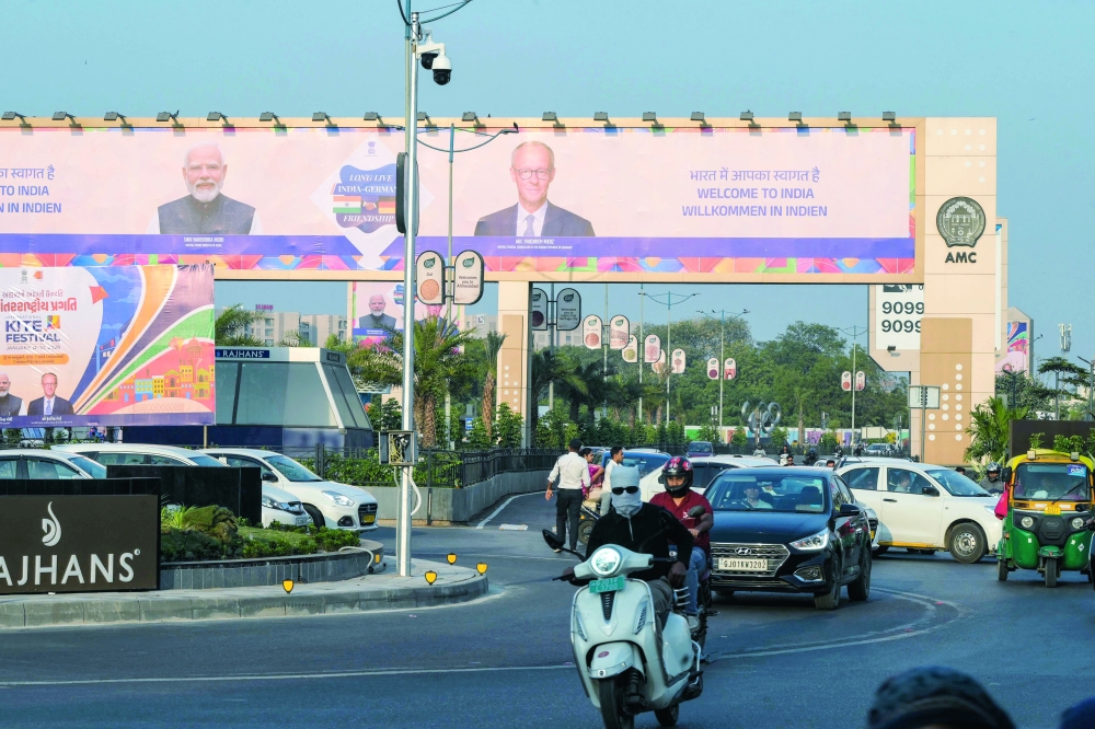 A billboard features India's PM Narendra Modi and German Chancellor Friedrich Merz, in Ahmedabad. — AFP