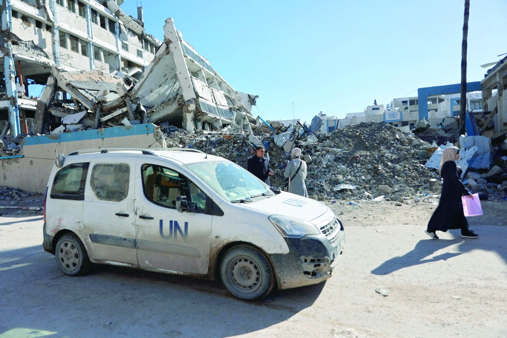 A United Nations vehicle drive past the destroyed United Nations Relief and Works Agency for Palestine Refugees in the Near East's (UNRWA) headquarters, in Gaza City on January 11, 2026. The majority of Gaza's 2.4 million people have been displaced, often multiple times, by the war that began with Hamas's attack on southern Israel on October 7, 2023. With displaced families living in tented camps, a serious concerns has been raised over their living conditions. 
