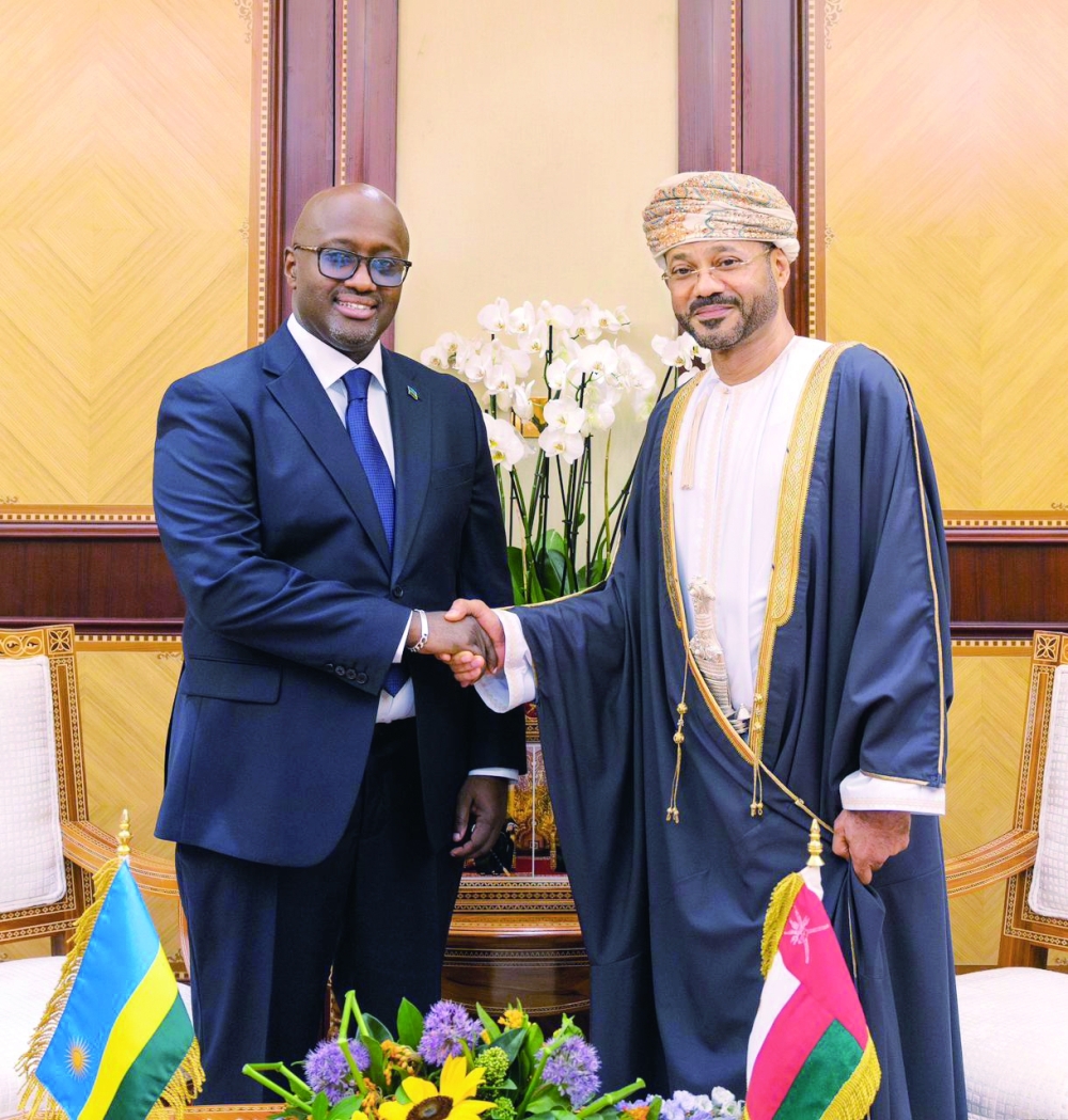 Sayyid Badr bin Hamad al Busaidy shakes hands with Olivier Jean Patrick Nduhungirehe.