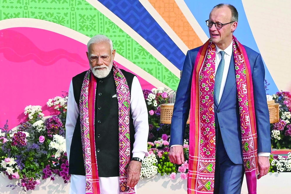 India's PM Narendra Modi (L) walks alongside German Chancellor Friedrich Merz, in Ahmedabad. — AFP