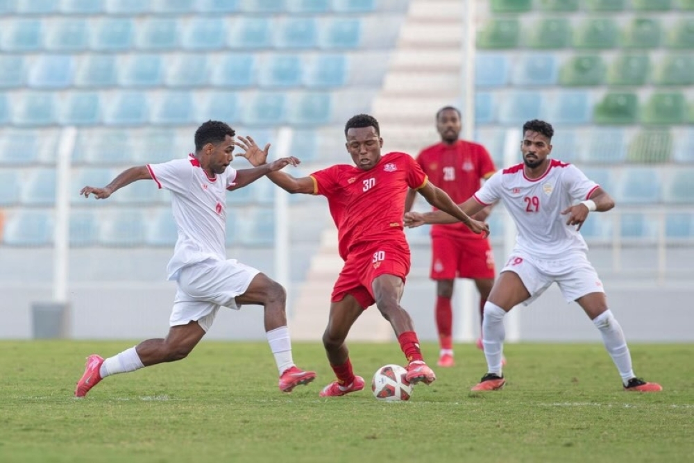 Oman Club and Dhofar Club players in action.