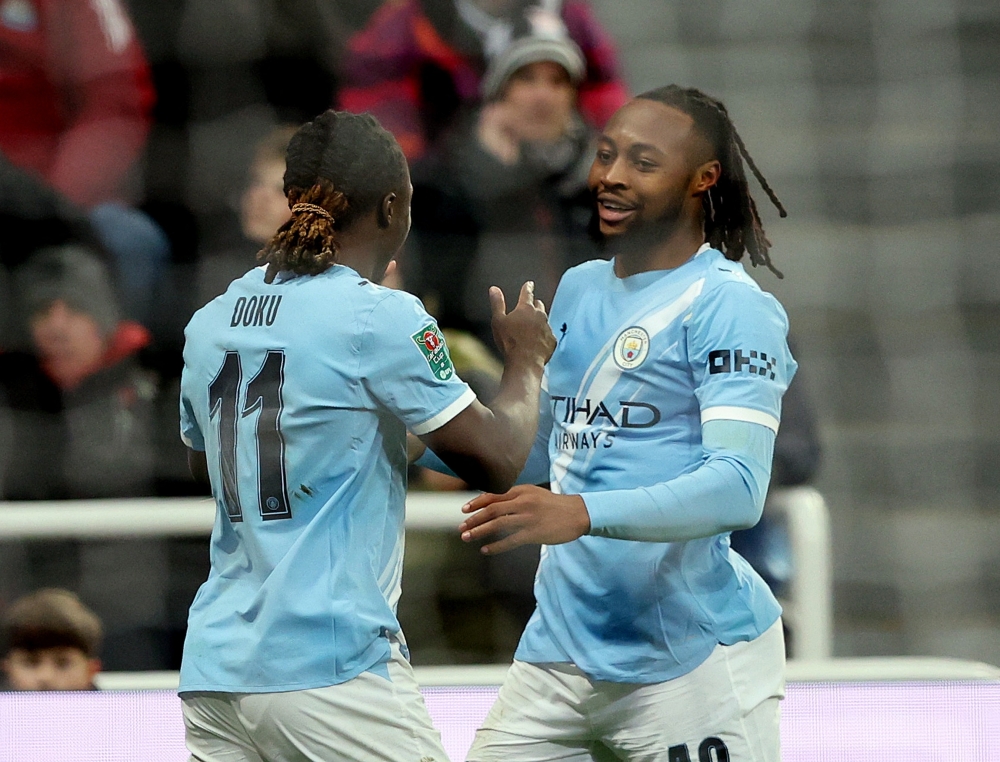 Manchester City's Antoine Semenyo celebrates scoring their first goal with Jeremy Doku 