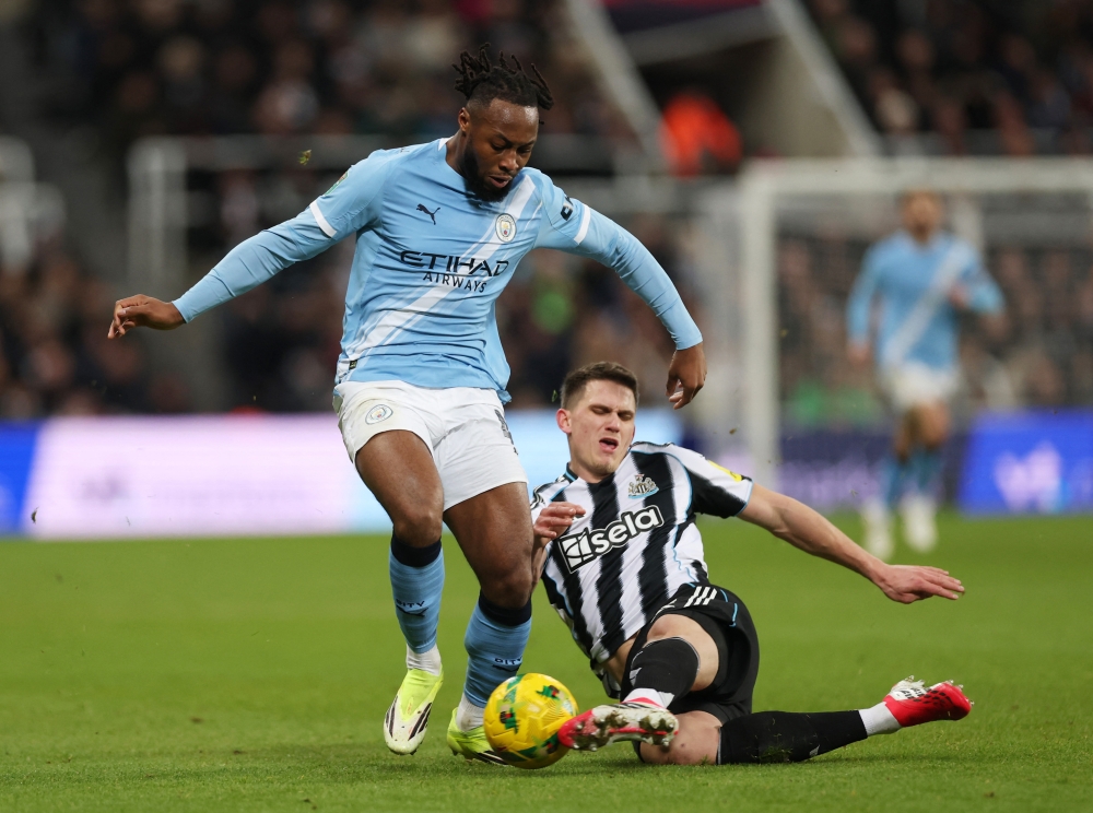   Manchester City's Antoine Semenyo in action with Newcastle United's Sven Botman 