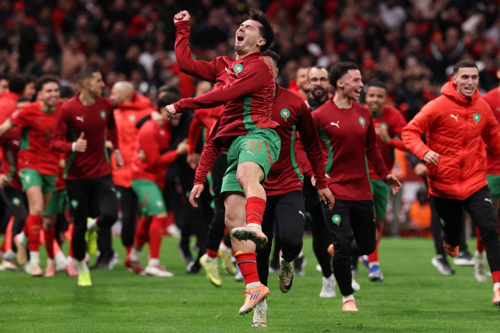 Morocco's forward #10 Brahim Diaz celebrates after the winning