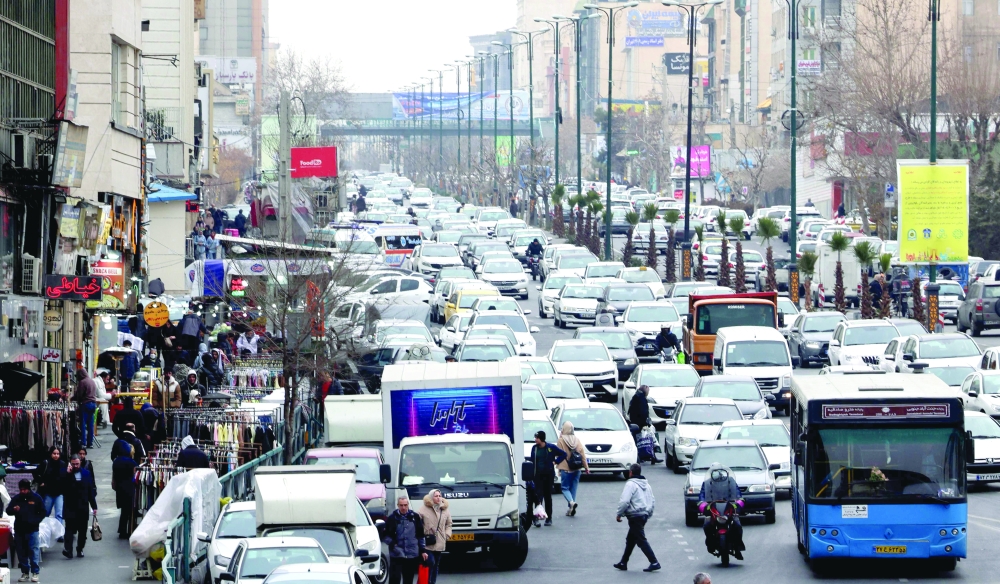 Commuters drive along a street in Tehran. - AFP