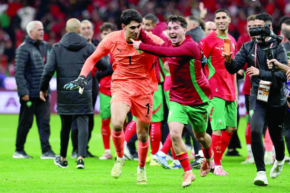 Morocco's goalkeeper Yassine Bounou and Morocco's forward Brahim Diaz celebrate after winning the Africa Cup of Nations (CAN) semi-final football match between Nigeria and Morocco at the Prince Moulay Abdellah stadium in Rabat on January 14, 2026.   (Photo by FRANCK FIFE / AFP)