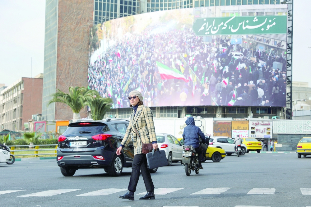 An Iranian woman walks on a street in Tehran on Thursday. — Reuters 